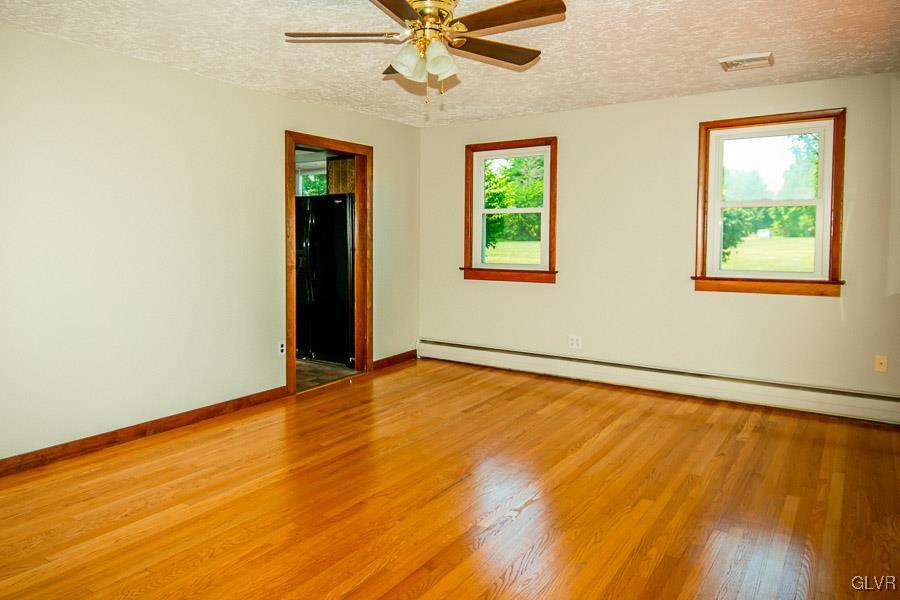 2121 7th Street Bethlehem, PA 18020 - Photo 3 of 14 a view of an empty room with a window and wooden floor