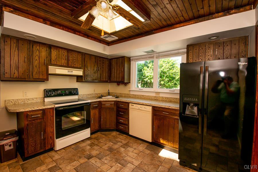 2121 7th Street Bethlehem, PA 18020 - Photo 4 of 14 a kitchen with stainless steel appliances granite countertop a stove sink and refrigerator