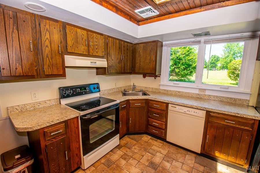 2121 7th Street Bethlehem, PA 18020 - Photo 5 of 14 a kitchen with a stove sink and cabinets