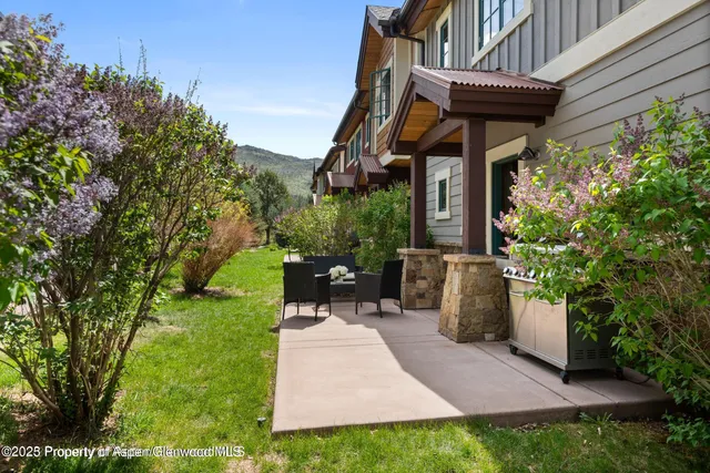 a view of a chairs and table in backyard of the house