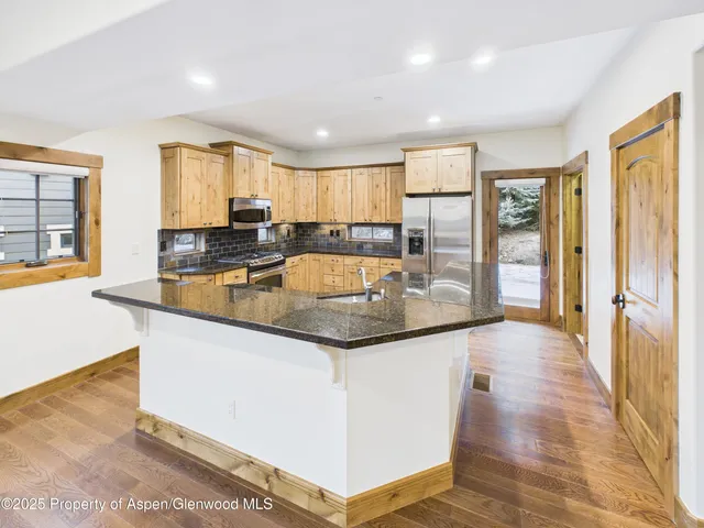 a kitchen with sink a refrigerator and cabinets