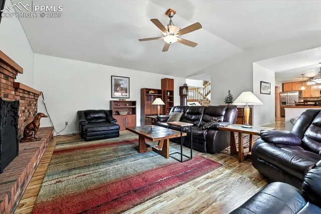 a living room with furniture a rug and a flat screen tv