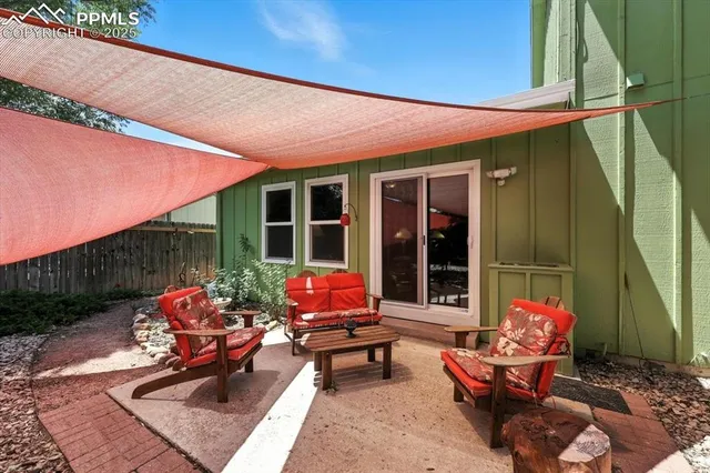 a backyard of a house with outdoor seating