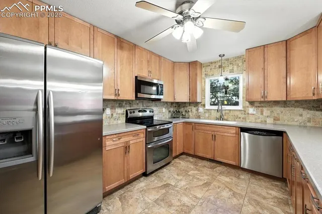 a kitchen with a refrigerator a microwave a sink and cabinets