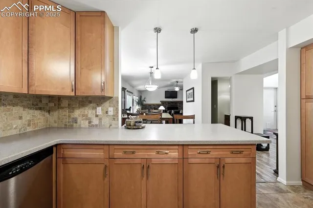 a kitchen with sink a refrigerator and cabinets