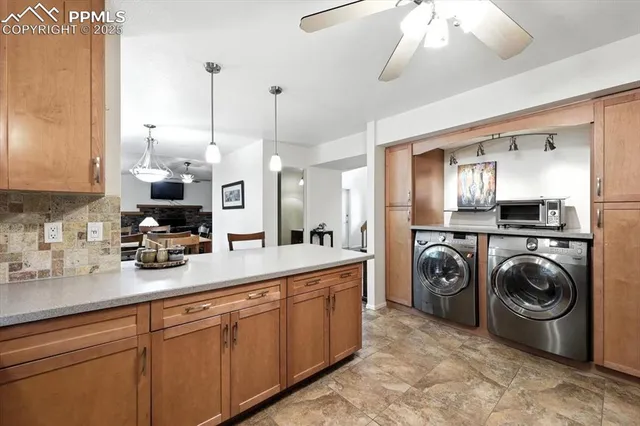 a large kitchen with stainless steel appliances granite countertop a lot of counter space and a sink