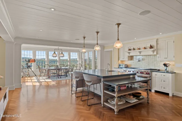 a room with stainless steel appliances granite countertop a stove and a refrigerator