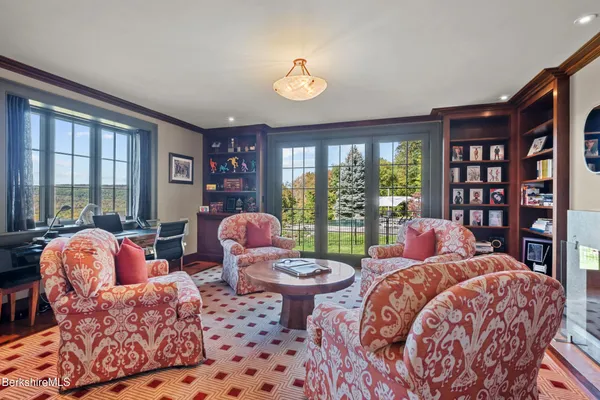 a kitchen with granite countertop a dining table chairs cabinets wooden floor and appliances