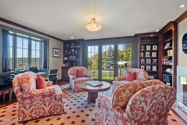 a kitchen with granite countertop a dining table chairs cabinets wooden floor and appliances