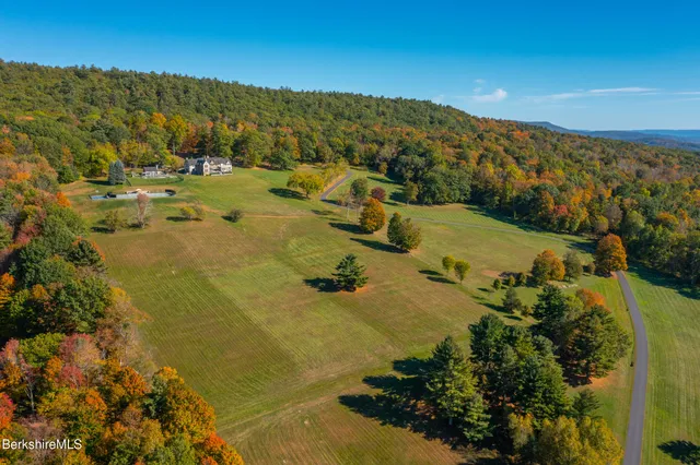 a front view of a house with a yard table and chairs
