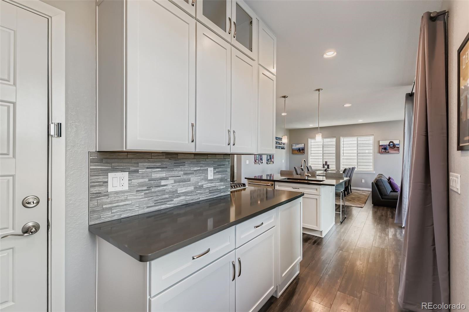86 Nova Court Erie, CO 80516 - Photo 14 of 50 a kitchen with sink cabinets and stove