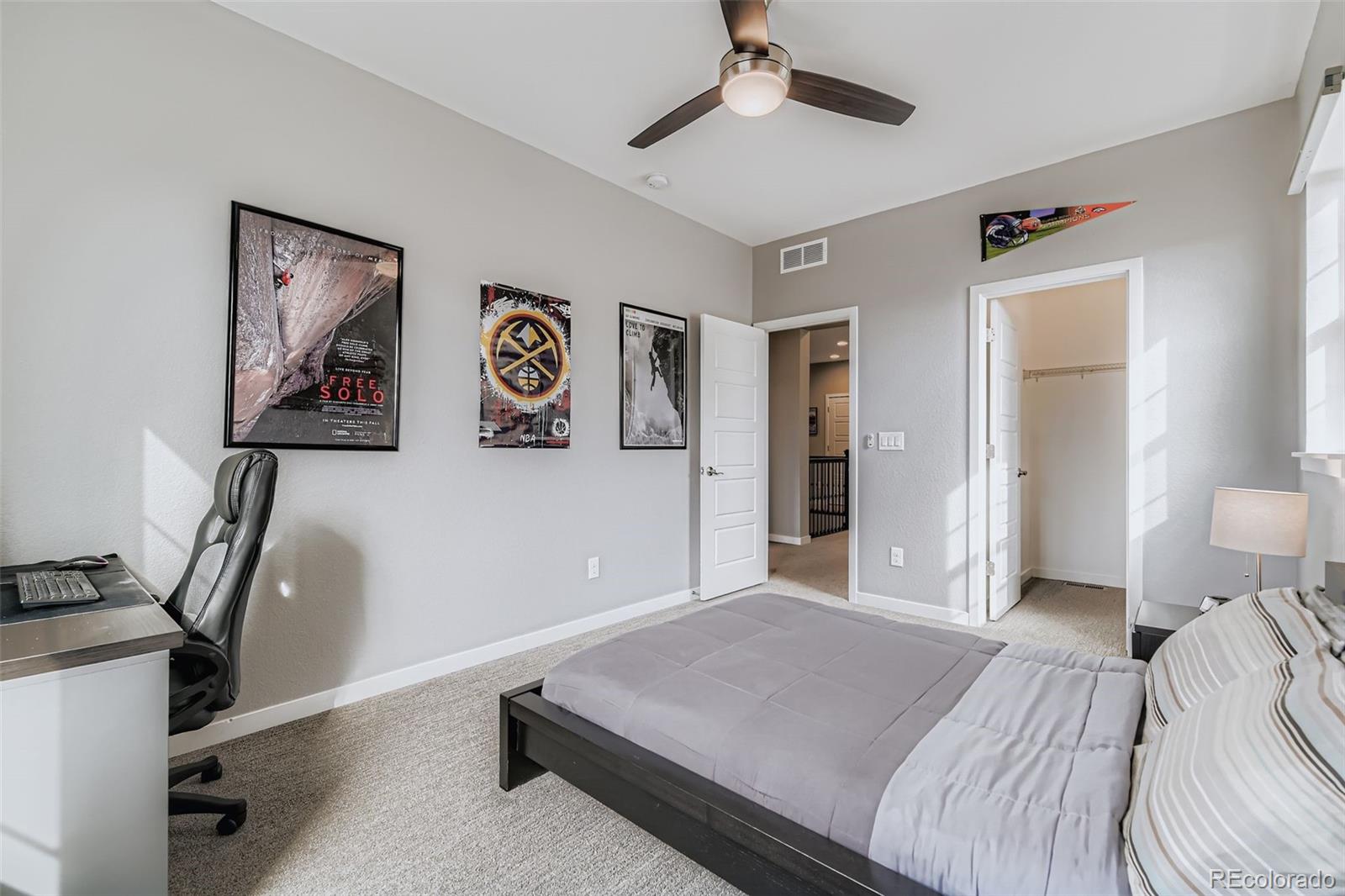 86 Nova Court Erie, CO 80516 - Photo 25 of 50 a bedroom with a bed and a chandelier