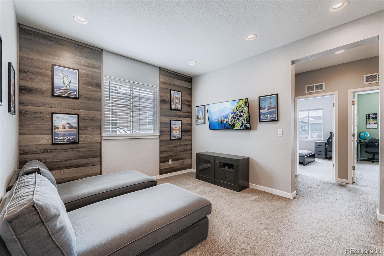 86 Nova Court Erie, CO 80516 - Photo 26 of 50 a living room with furniture and a flat screen tv