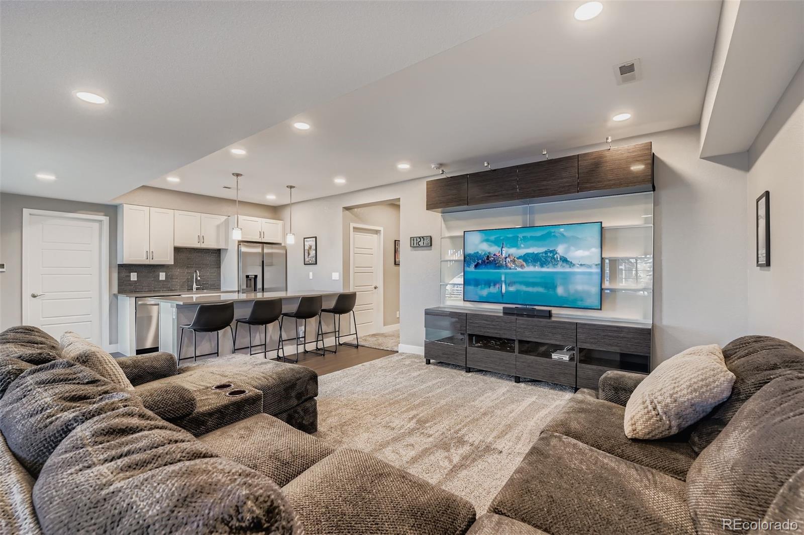 86 Nova Court Erie, CO 80516 - Photo 29 of 50 a living room with furniture and a flat screen tv