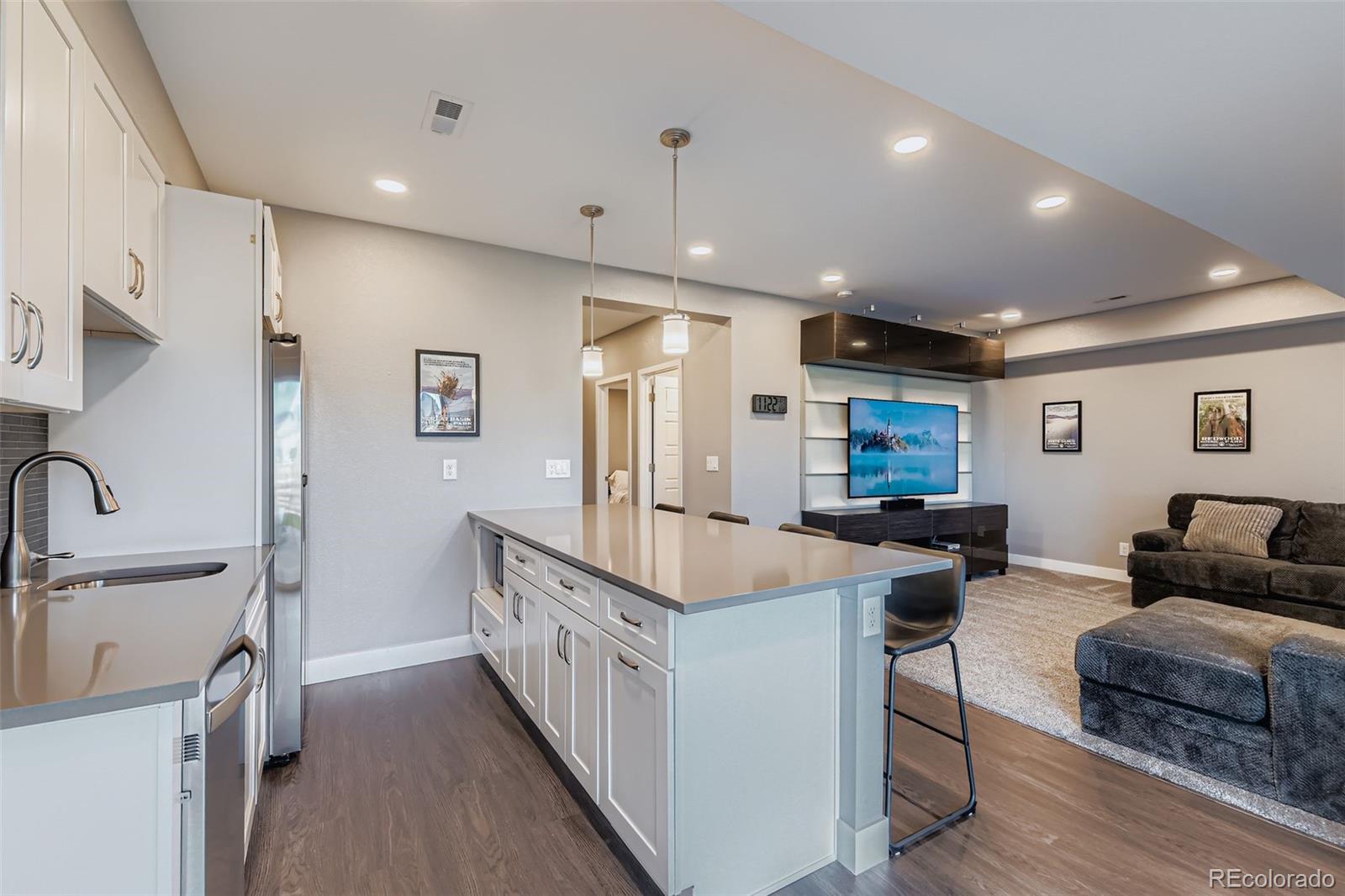 86 Nova Court Erie, CO 80516 - Photo 32 of 50 a living room with stainless steel appliances kitchen island a sink and a refrigerator