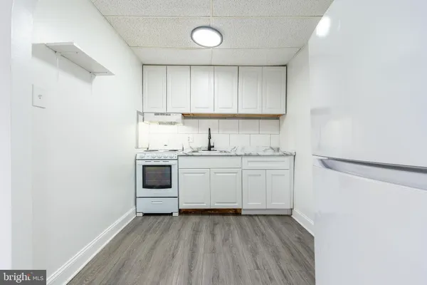 a kitchen with a sink cabinets and a window