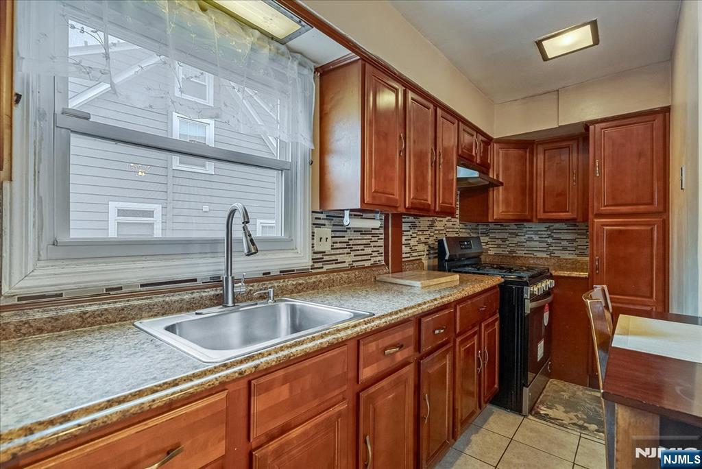 15 Belle Terre Road West Orange, NJ 07052 - Photo 10 of 29 a kitchen with stainless steel appliances granite countertop a sink stove and cabinets