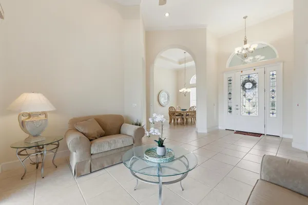 a large white kitchen with stainless steel appliances granite countertop a stove a sink a refrigerator and a cabinets