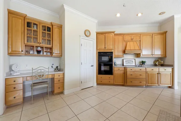 a living room with furniture and a view of kitchen