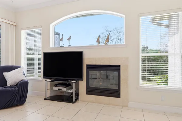 a spacious bathroom with a double vanity sink a large mirror a bathtub and next to a window