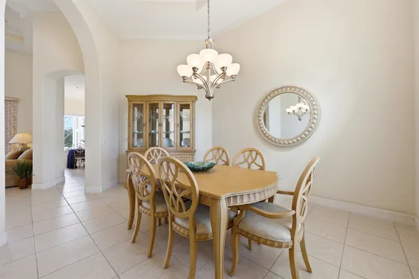 a living room with furniture a chandelier and a mirror