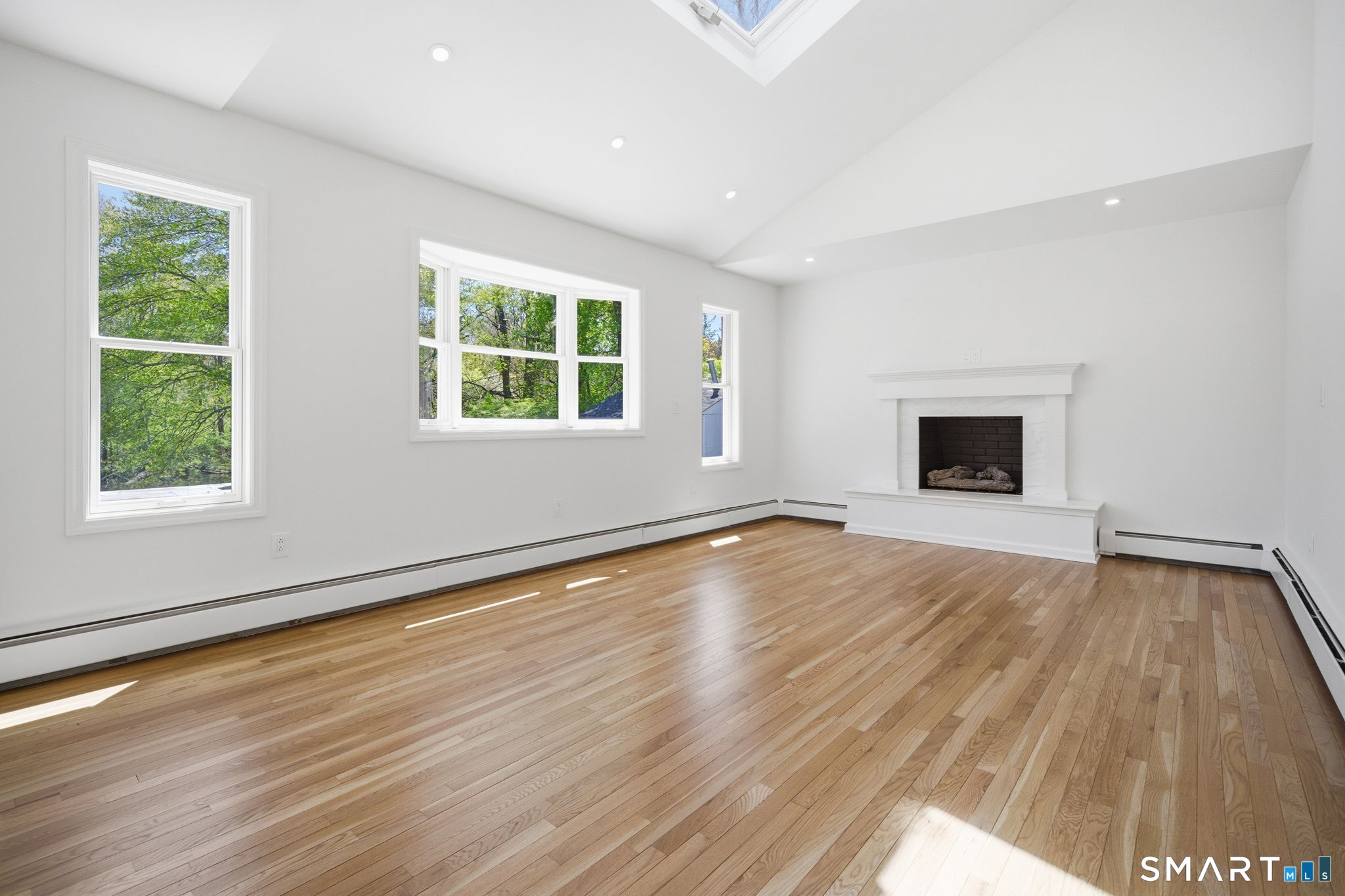 5 Betmarlea Road Norwalk, CT 06850 - Photo 14 of 33 Family Room w/Gas fireplace, skylights and plenty of natural light