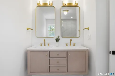 a bathroom with a double vanity sink and mirror