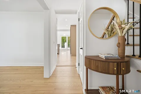 a dining room with furniture and a mirror