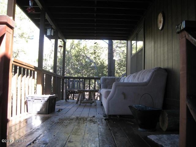 2910 Red Cinder Road Heber, AZ 85928 - Photo 17 of 27 a view of a porch with furniture and wooden floor