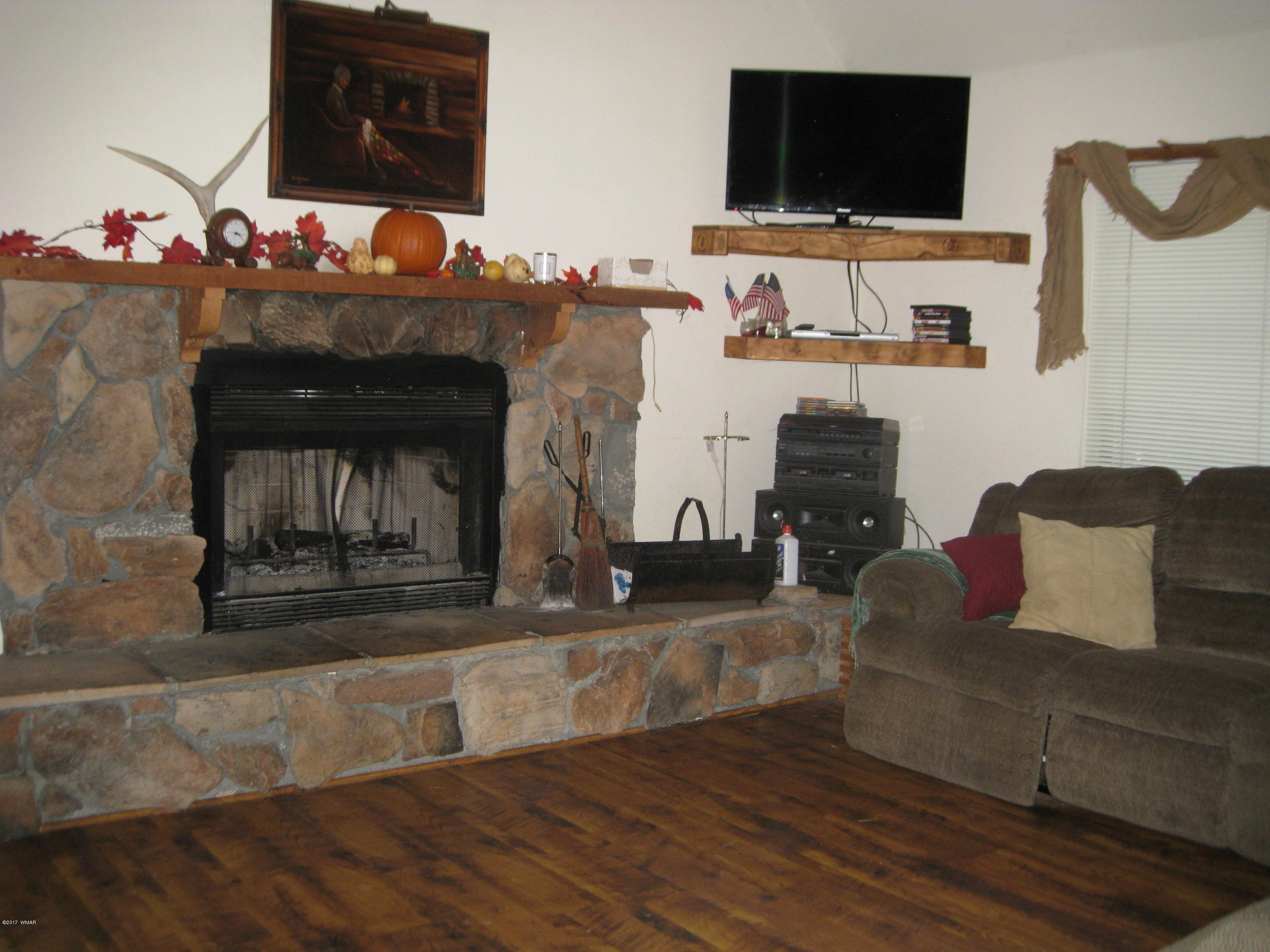 2910 Red Cinder Road Heber, AZ 85928 - Photo 3 of 27 a living room with fireplace furniture and a flat screen tv