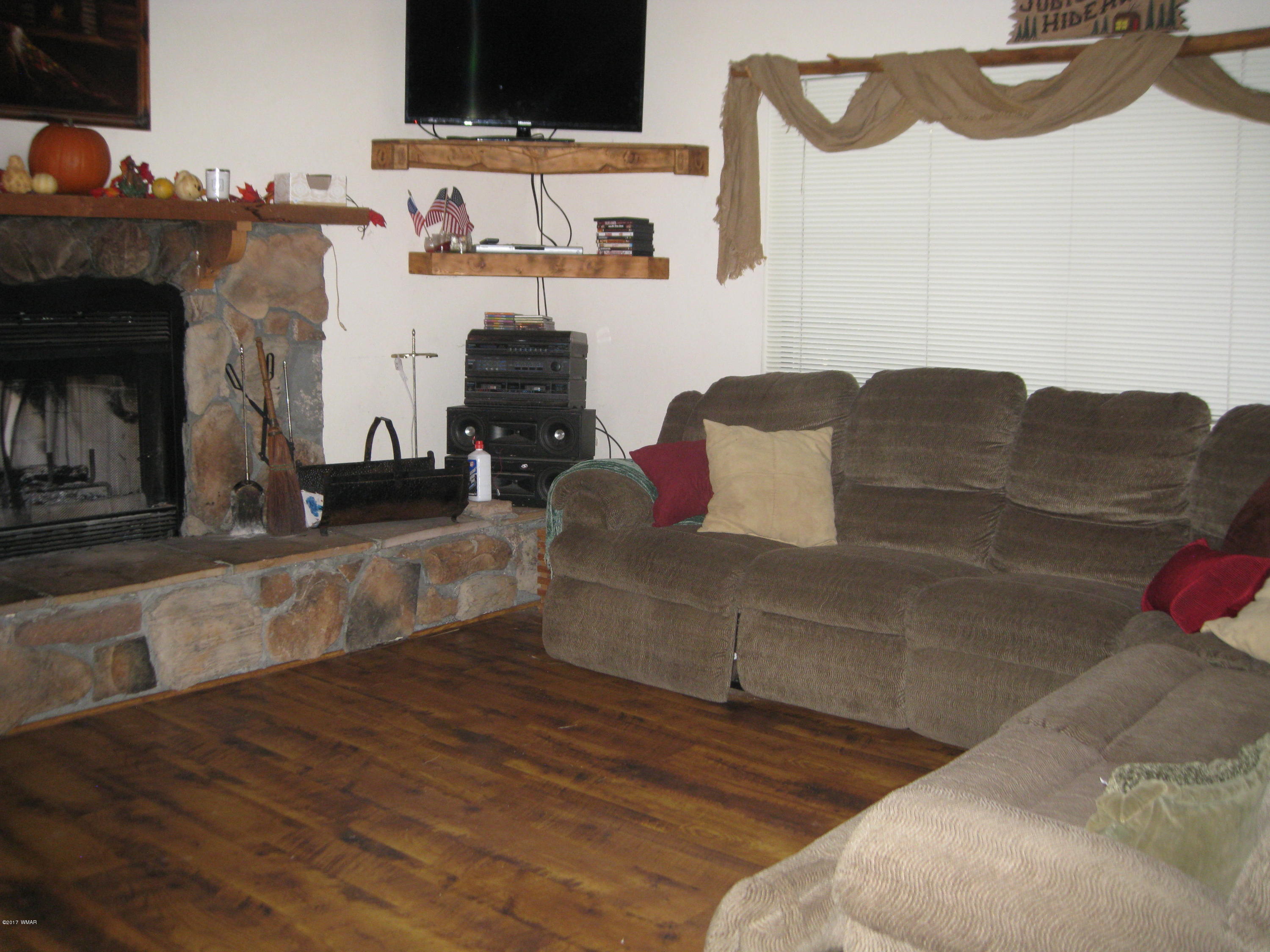 2910 Red Cinder Road Heber, AZ 85928 - Photo 5 of 27 a living room with furniture and a fireplace