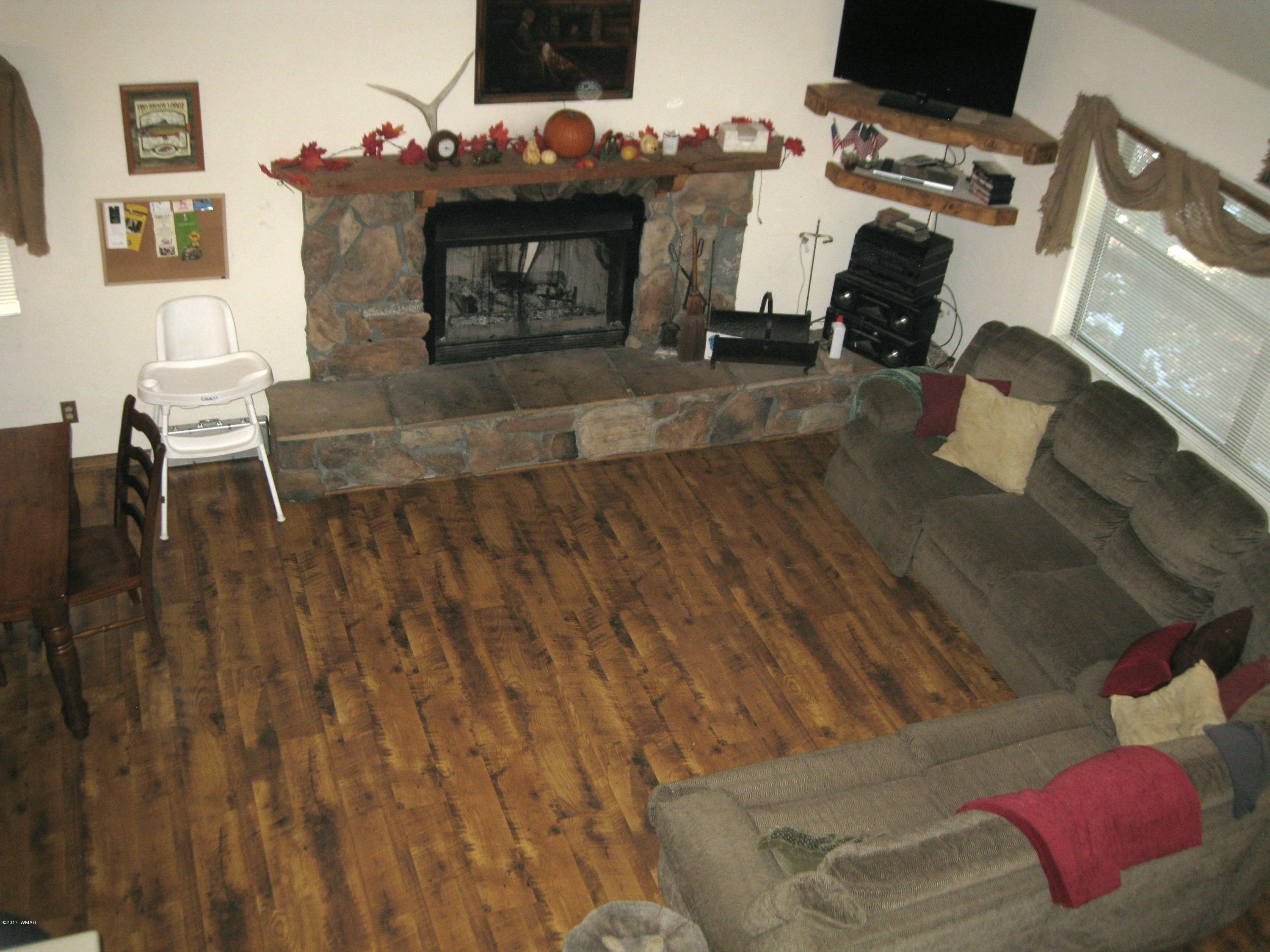2910 Red Cinder Road Heber, AZ 85928 - Photo 7 of 27 a living room with furniture and a fireplace