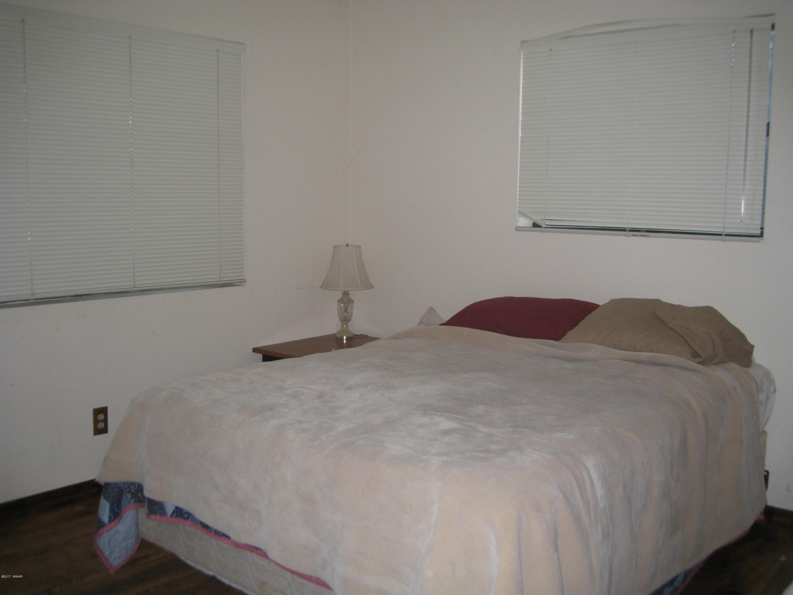 2910 Red Cinder Road Heber, AZ 85928 - Photo 8 of 27 a bedroom with a bed and a window