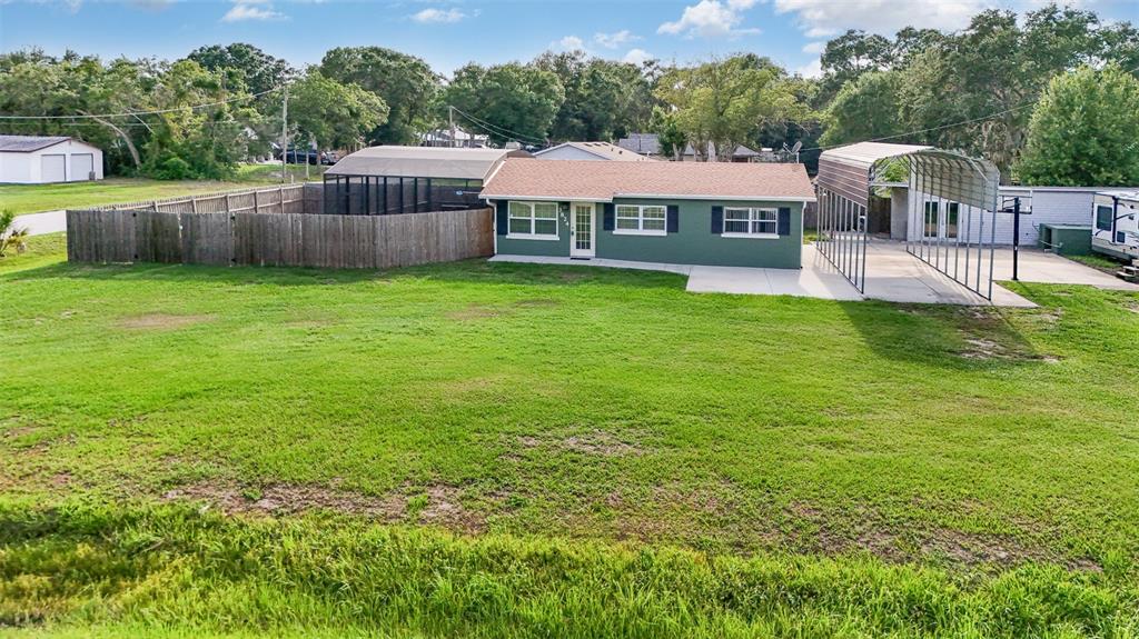 a view of a house with a yard and sitting area