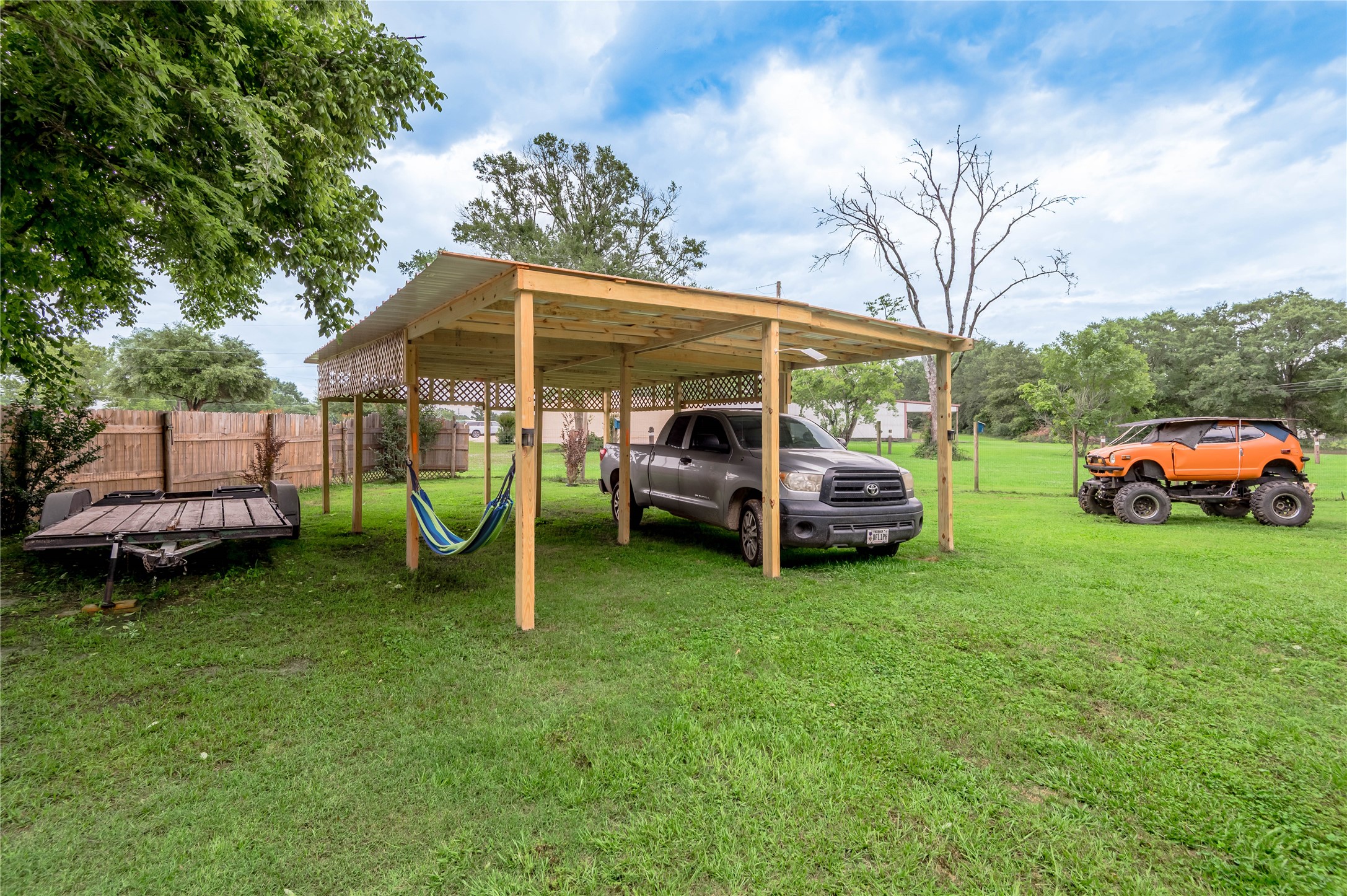159 Pecan Avenue Groveton, TX 75845 - Photo 18 of 27 a view of a backyard with a car parked