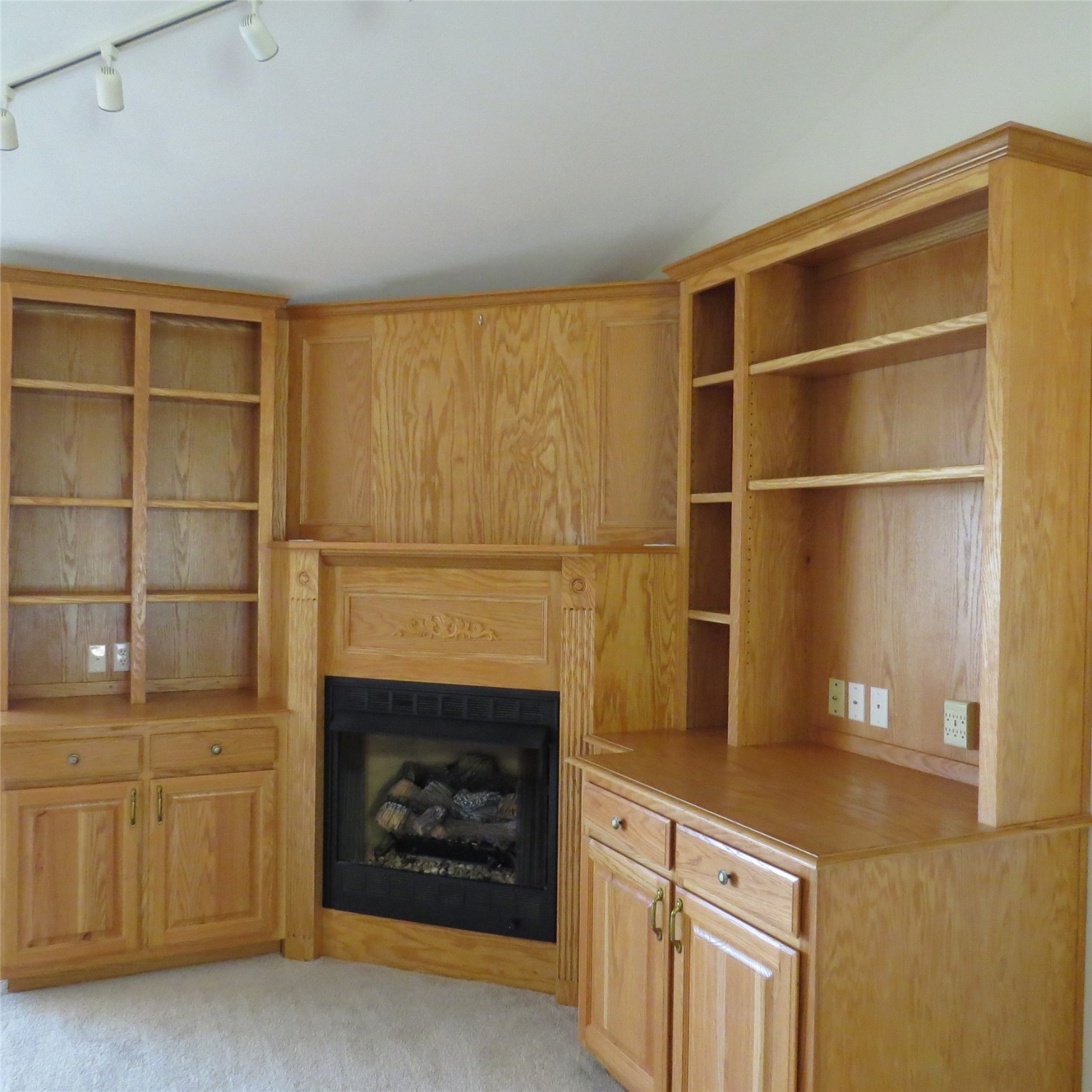 651 Sam Houston Loop Point Blank, TX 77364 - Photo 21 of 47 Livingroom built ins with propane fireplace, bookshelves, drawers and cabinets.