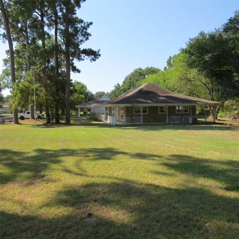 a view of a swimming pool with lawn chairs and plants