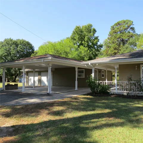 a view of a house with a yard balcony and sitting area