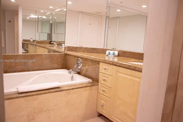 a bathroom with a bathtub and a sink