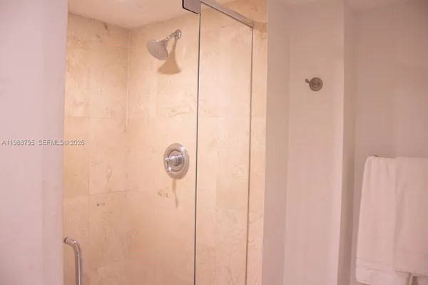 a bathroom with a glass shower door
