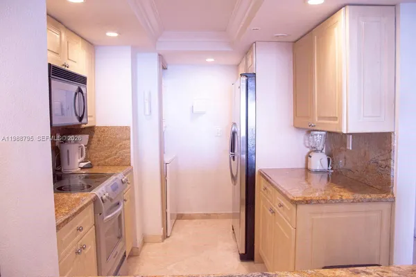 a bathroom with a granite countertop sink a mirror and a shower