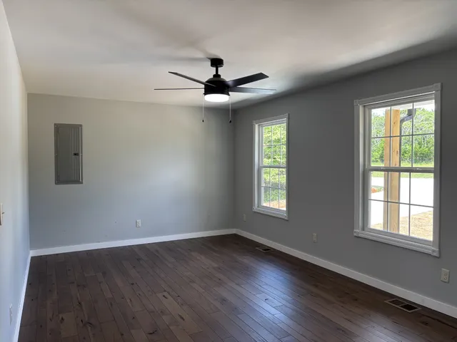 wooden floor in an empty room with a window
