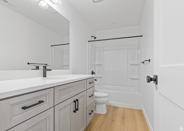 11214 South Easy Bee Road, Unit 270 South Jordan, UT 84009 - Photo 19 of 31 Contemporary bathroom featuring a light wood-finish vanity with matte black hardware, a white countertop, and an integrated sink