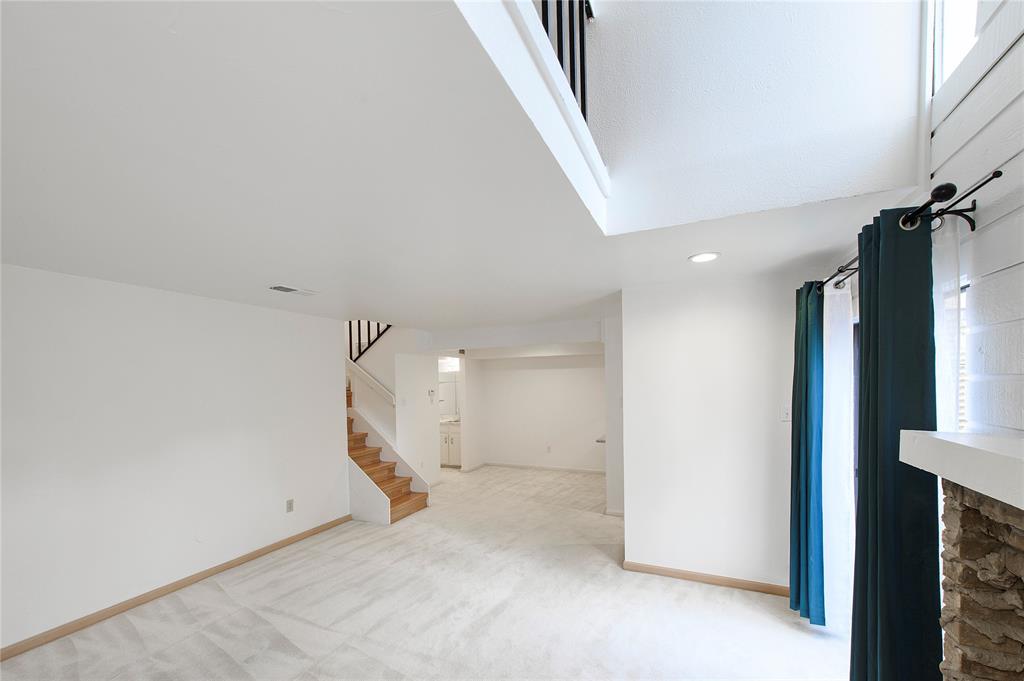 5626 Preston Oaks Road, Unit 5A Dallas, TX 75254 - Photo 16 of 20 Living room adjacent to dining room and wet bar area with hidden washer dryer space.