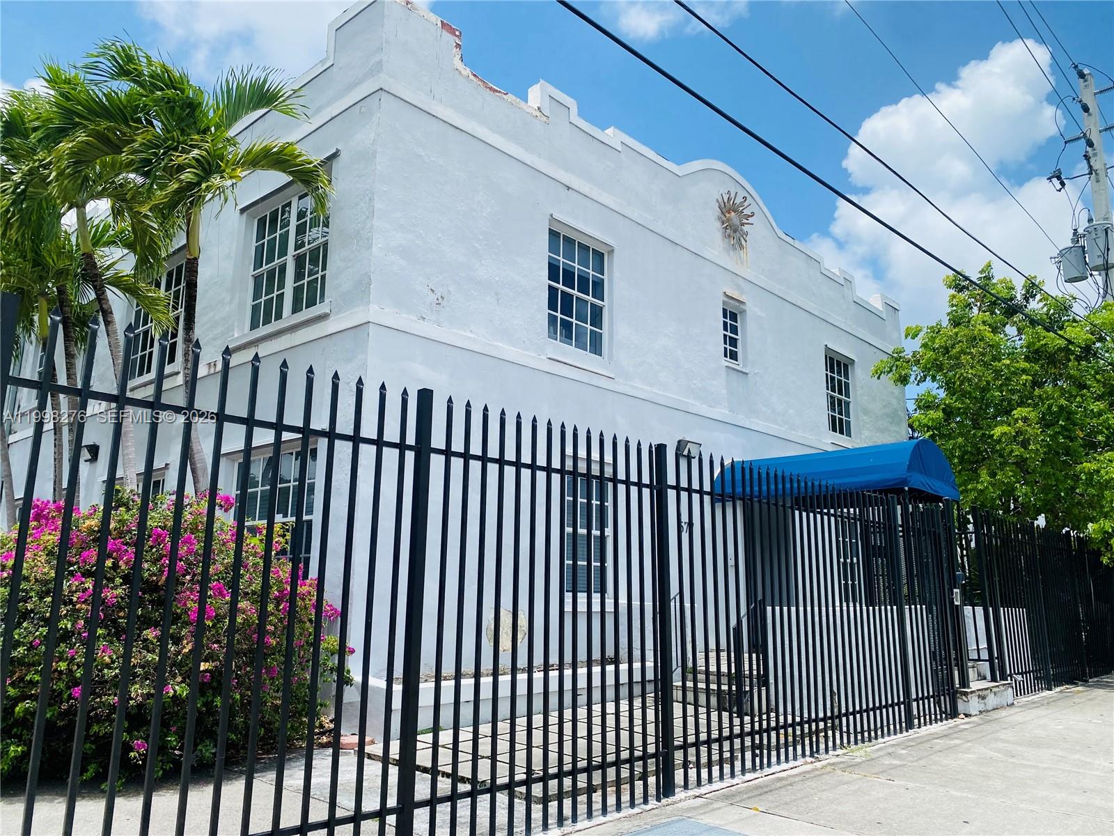 577 Northeast 62nd Street, Unit 8 Miami, FL 33138 - Photo 1 of 21 a view of a house with a flower garden