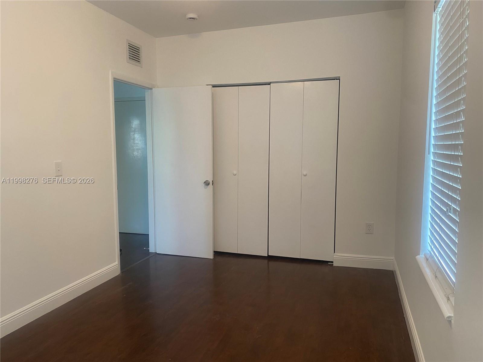 577 Northeast 62nd Street, Unit 8 Miami, FL 33138 - Photo 11 of 21 an empty room with wooden floor