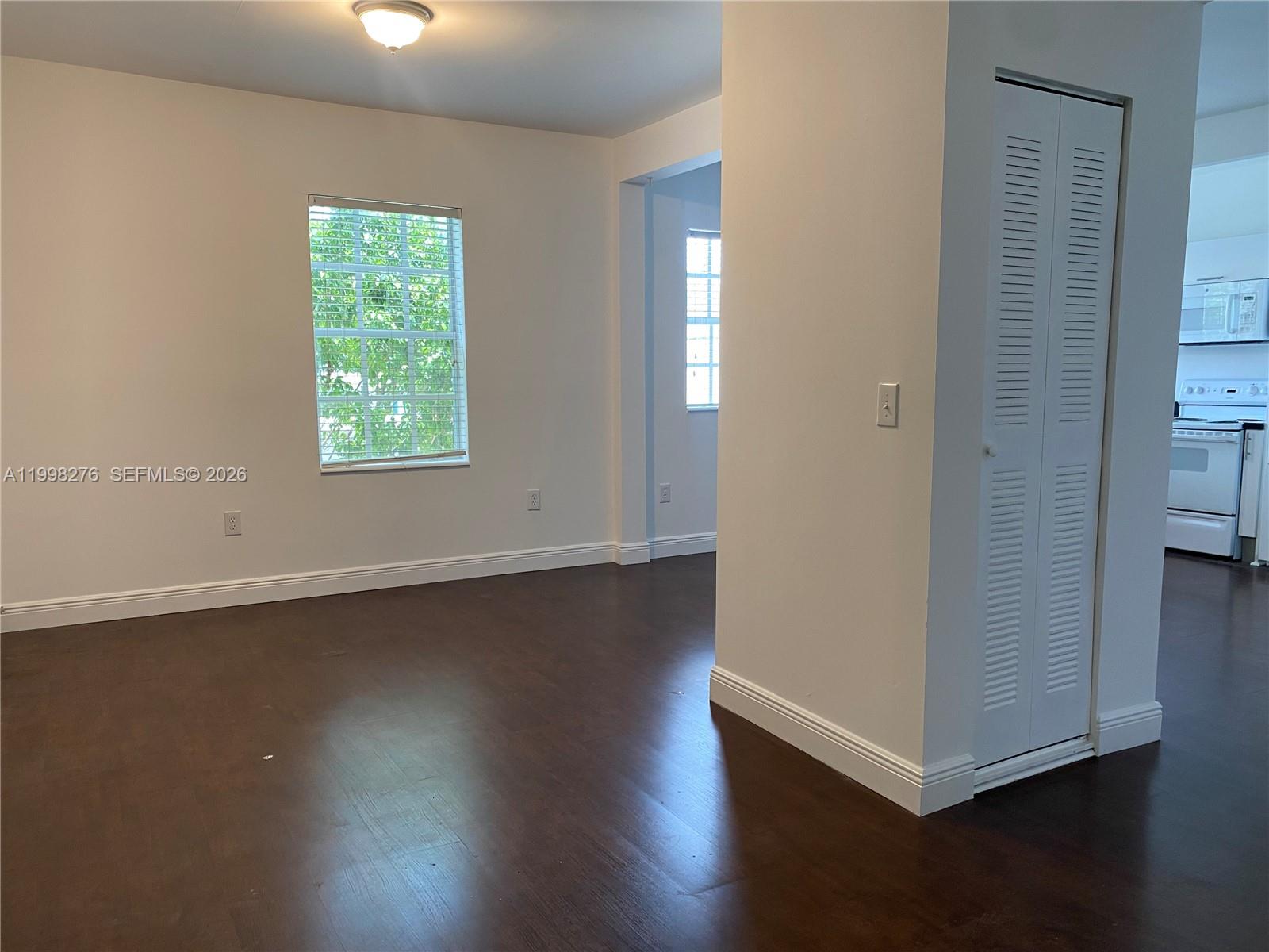577 Northeast 62nd Street, Unit 8 Miami, FL 33138 - Photo 13 of 21 an empty room with wooden floor and windows