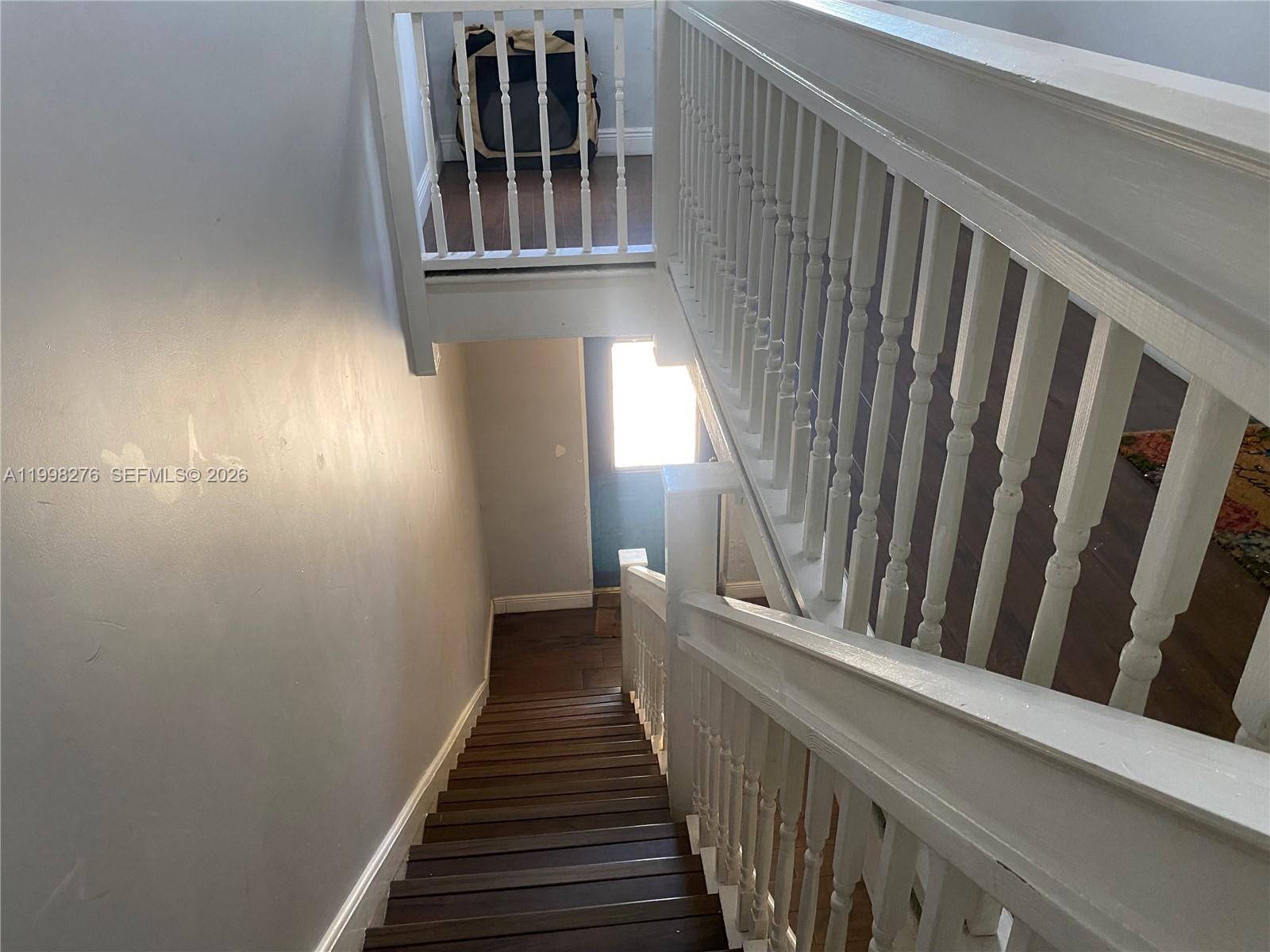 577 Northeast 62nd Street, Unit 8 Miami, FL 33138 - Photo 15 of 21 a view of staircase with railing and a window
