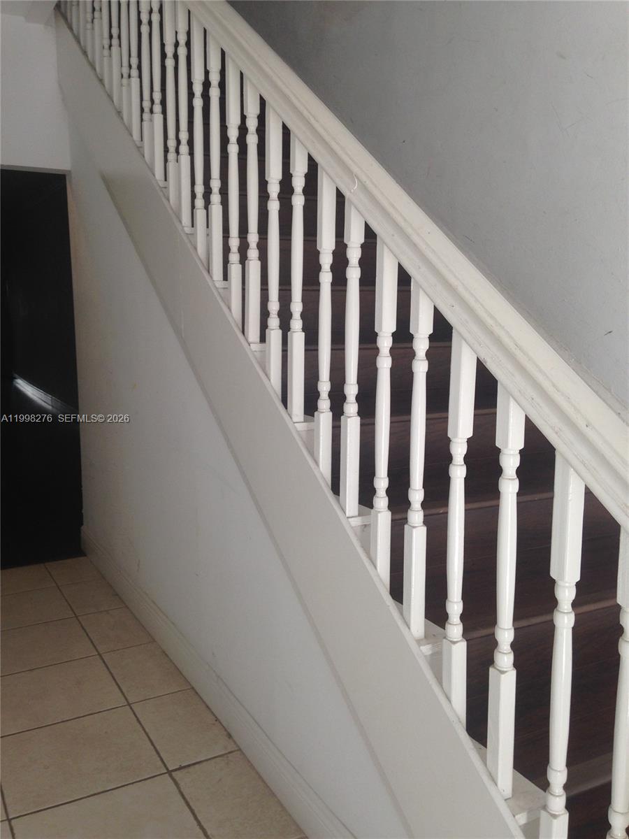 577 Northeast 62nd Street, Unit 8 Miami, FL 33138 - Photo 18 of 21 a view of staircase with railing and a window