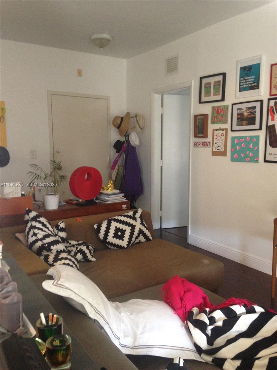 577 Northeast 62nd Street, Unit 8 Miami, FL 33138 - Photo 19 of 21 a bedroom with a bed and a wooden floor
